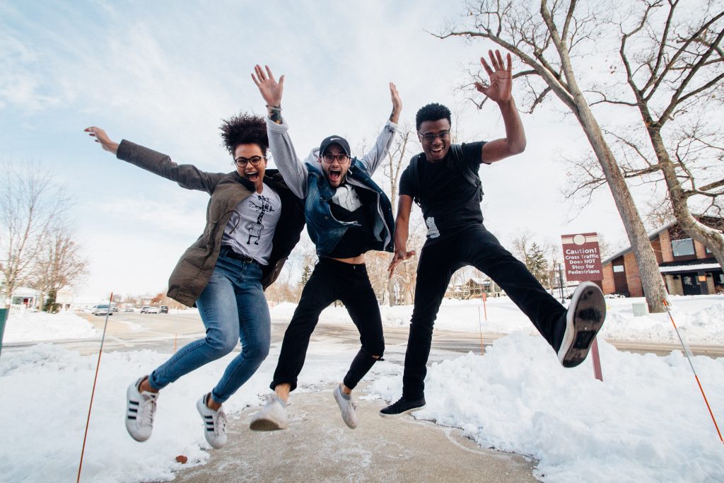 Three men jumping in the snow