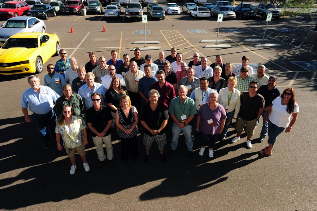 Group of people in parking lot looking at camera