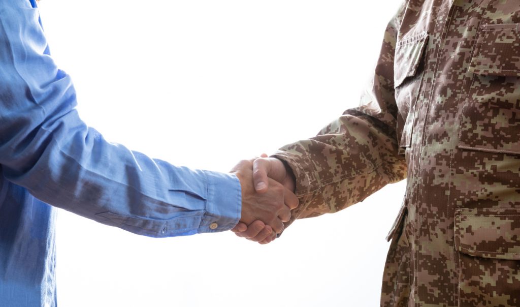 Civilian and Military men shaking hands