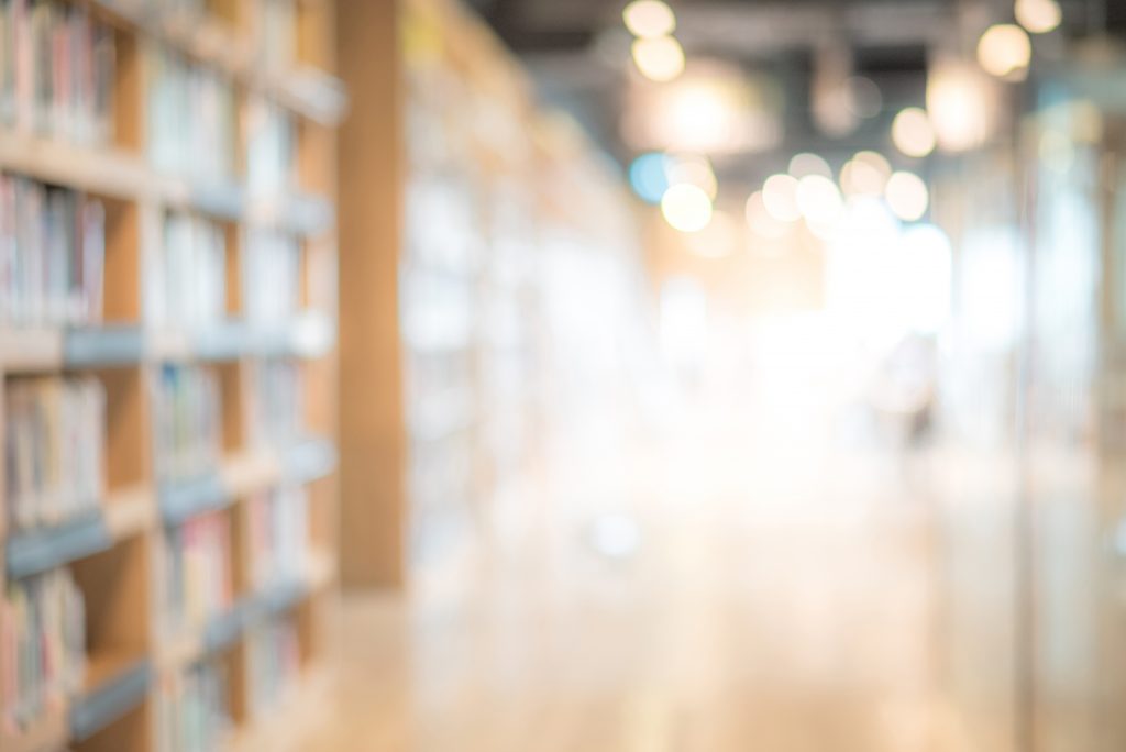 Abstract blurred public library interior space. blurry room with bookshelves by defocused effect. use for background or backdrop in business or education concepts