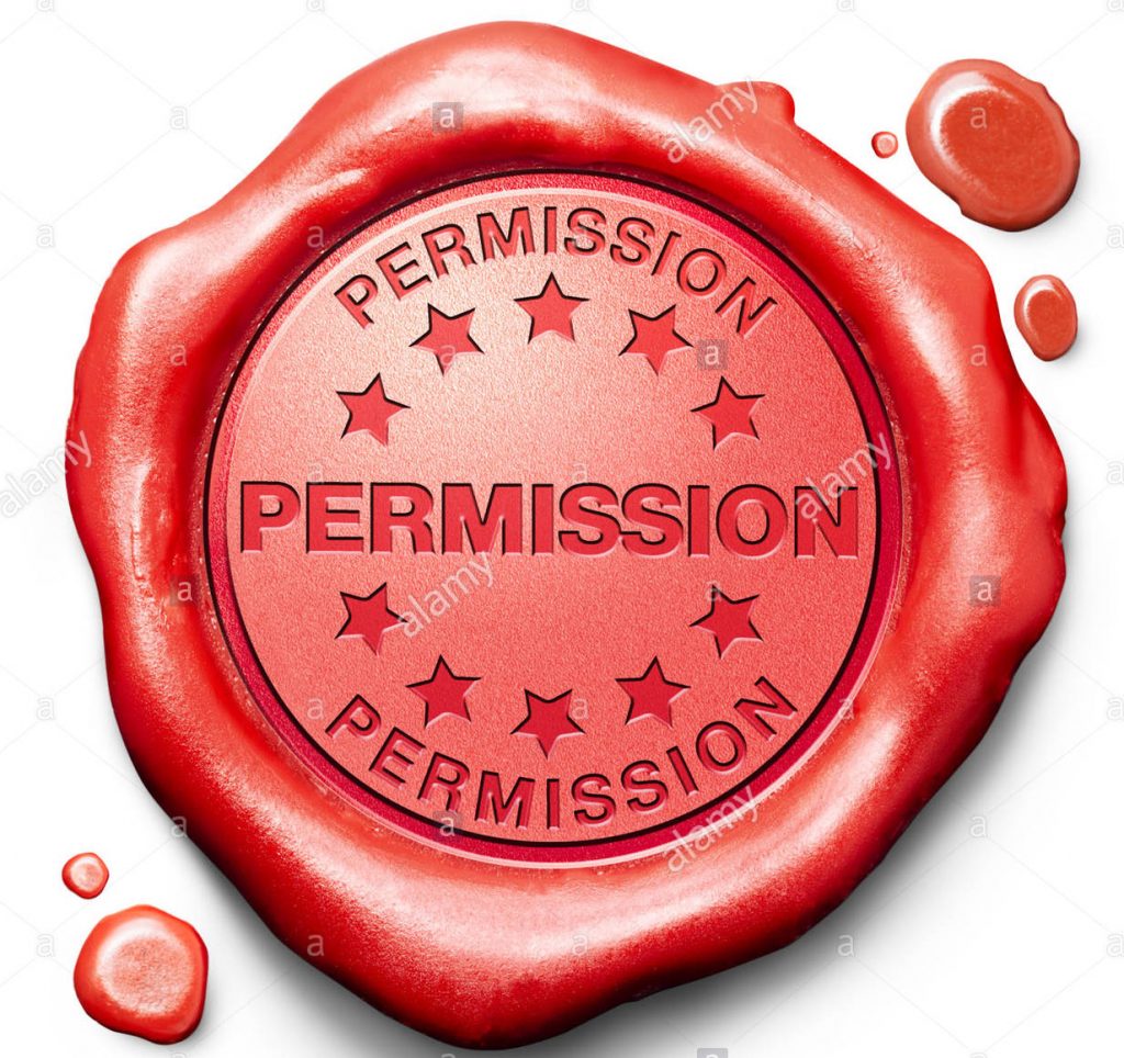 Red wax seal with words "permission" stamped into it.