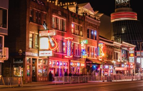 Downtown Nashville street with neon lights and signs.